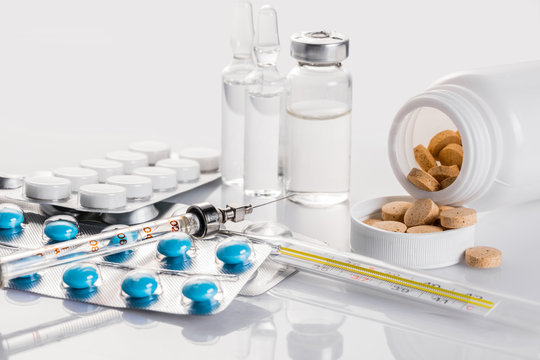 background, a variety of medical drugs and syringe closeup