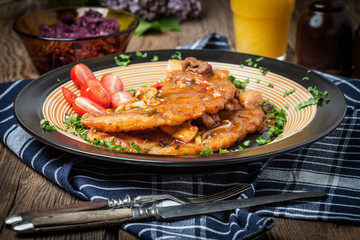 Potato pancakes with meat stew served on a plate.