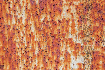 Rusty metal wall background with streaks of rust.