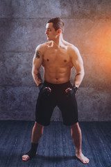 Fototapeta premium Portrait of a street fighter on a gray background.