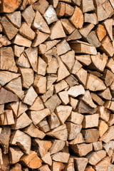 Fire wood natural background texture, chopped firewood vertical image