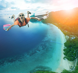 flying man happiness vacation time over beautiful blue sea traveling destination