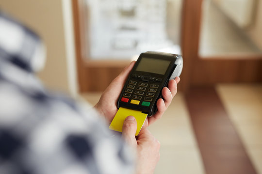 Man using payment terminal paying with credit card
