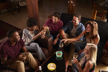 Young adults socialising at a party at home, elevated view