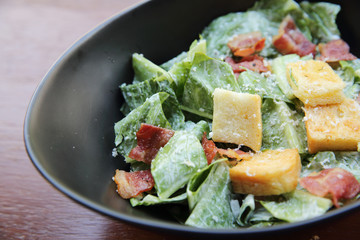 caesar salad on wood background