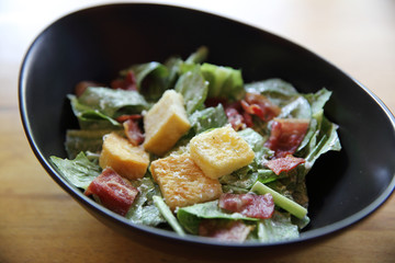 caesar salad on wood background