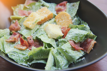 caesar salad on wood background