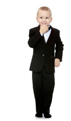 Trendy little boy in a black suit with a tie.