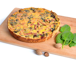 Pie with spinach and ham on the board. Isolated.
