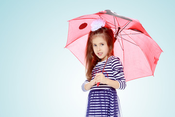 Little girl hiding under an umbrella.