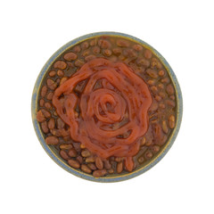 Bacon onion flavored baked beans in a bowl with ketchup on the food isolated on a white background.