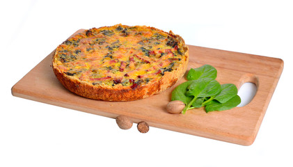 Pie with spinach and ham on the board. Isolated.