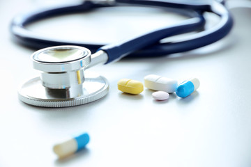 pills or capsules and stethoscope On the doctor's table