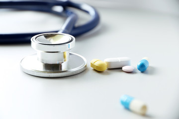 pills or capsules and stethoscope On the doctor's table