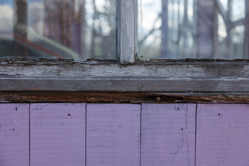 a old colored wooden boarded wall and window