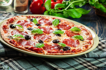 Pizza pepperoni with olives served