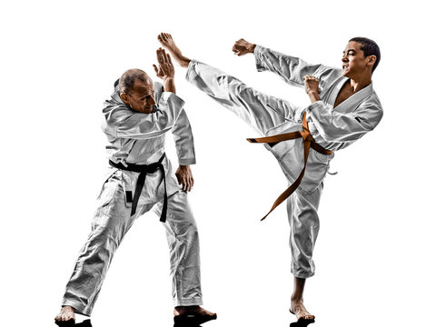 two karate men sensei and teenager student fighters fighting isolated on white background