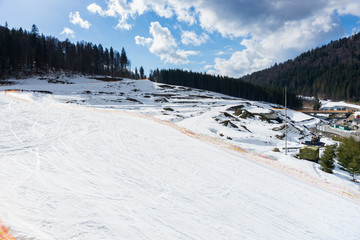 Fototapeta na wymiar Empty fenced track for skiers with stunning mountain view