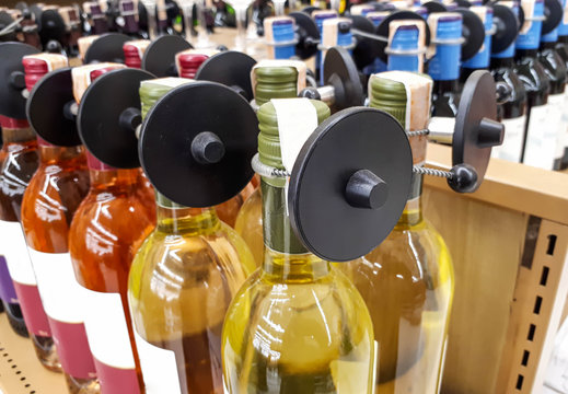 RFID hard tag isolated - Shoplifting and anti-theft system - Electronic Article Surveillance system used with high-value goods - Alcoholic drinks bottle
