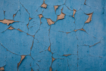 dark blue peeling paint on brown cement wall texture