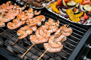 Barbecue grill party. Tasty Fresh food. Shrimps  spit and Beef rolls with bio young spices, chicken strips. bio vegetables