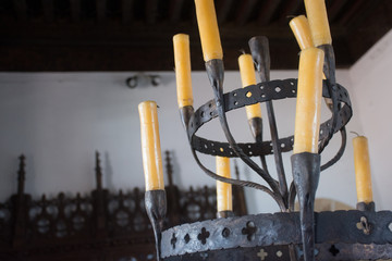 Forged candelabrum with wax candles in the old house