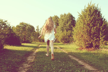 Adorable caucasian girll is jumping and smiling.