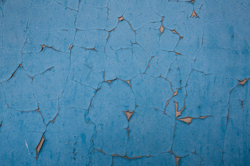 dark blue peeling paint on brown cement wall texture