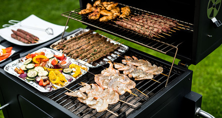 Barbecue grill party. Tasty Fresh food. Shrimps  spit and Beef rolls with bio young spices, chicken strips. bio vegetables