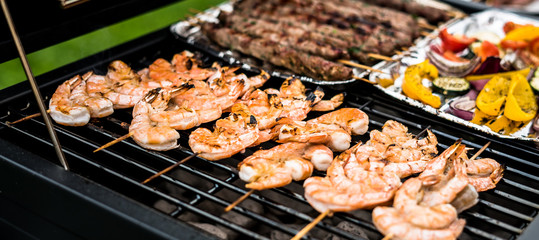 Barbecue grill party. Tasty Fresh food. Shrimps  spit and Beef rolls with bio young spices, chicken strips. bio vegetables
