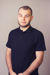 Portrait of a young bearded man on a white background.