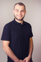 Portrait of a young bearded man on a white background.