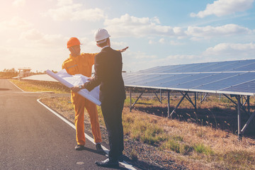 engineer and foreman discussing construction project solar power plant 