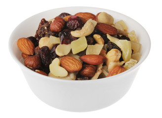 nuts and candied fruits in white bowl on white background isolate