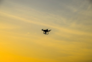 Quadrocopters silhouette against the background of the sunset