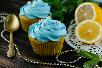 Cupcakes with blue decoration of a protein cream and beads