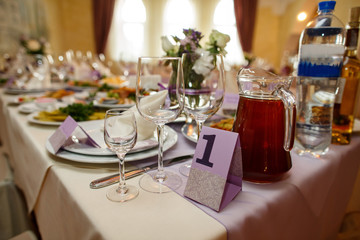 Wedding table with food and drinks for bride, groom and guests