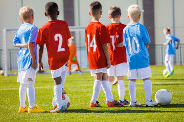 Obraz premium Kids Junior Football Training session. Soccer Training for Kids. Children Practice Soccer on the Pitch