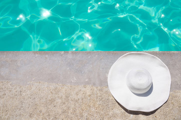 Fototapeta na wymiar Summer hat near the pool