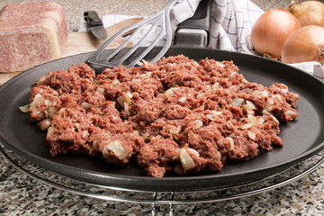 corned beef and onion on a pan