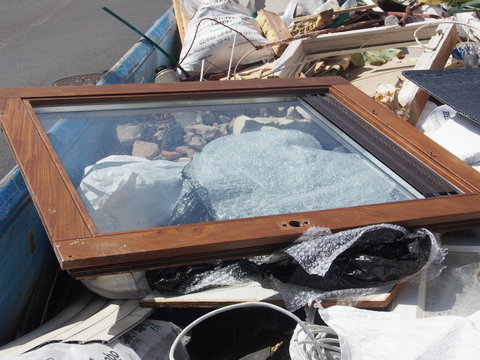 Sanierung: Altfenster auf Müllcontainer