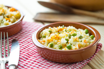 Healthy Rice with Carrot and Peas on Light Wooden Background