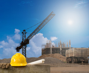 Construction industry building on high ground with yellow helmet and paper work