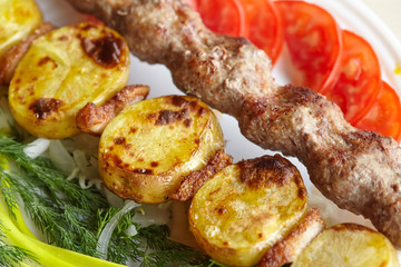 Barbecue Lula Kebab with minced meat, fresh vegetables and greens
