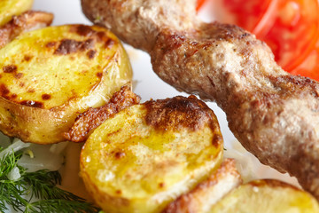 Barbecue Lula Kebab with minced meat, fresh vegetables and greens
