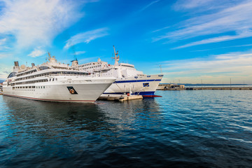 Fototapeta na wymiar Cruiser Mediterranean. / Seafront view at anchored luxury big boats in Split sea port, Croatia, european travel places.