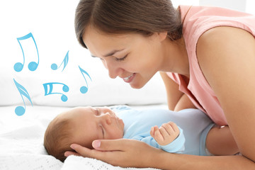 Portrait of young mother and her sleeping baby, close up view