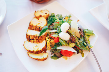 A plate of meat salad salad leaves and boiled egg
