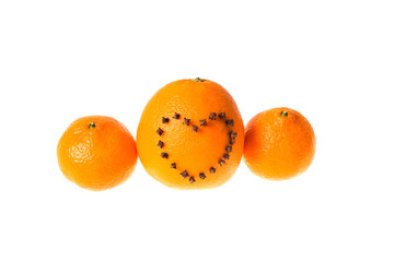 Fresh juicy bright tangerine and orange decorated with a heart of carnation on a white background.