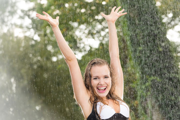 Happy girl in summer rain